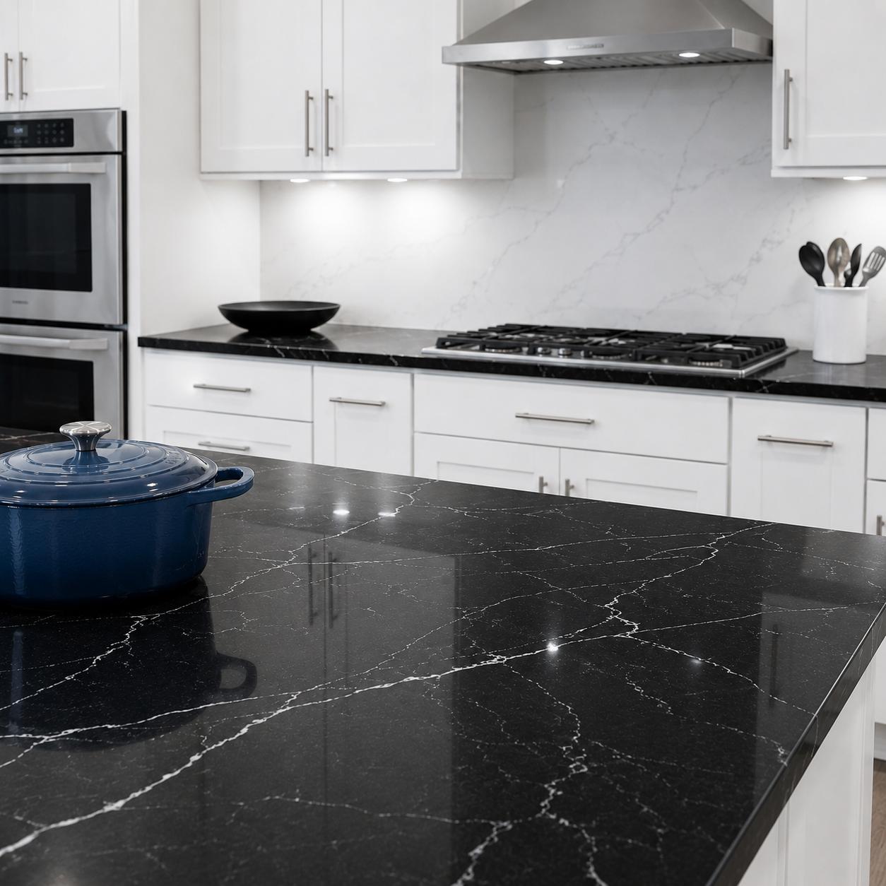 Black quartz kitchen island countertop with white cabinets
